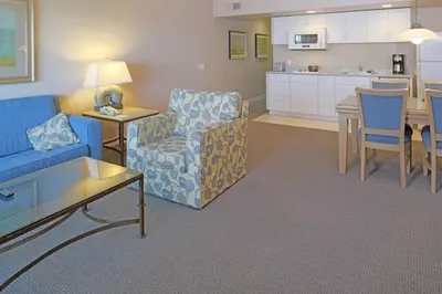 a living room with a blue couch and a kitchen at Diamond - Riviera Beach and Spa Resort 1bd in Dana Point