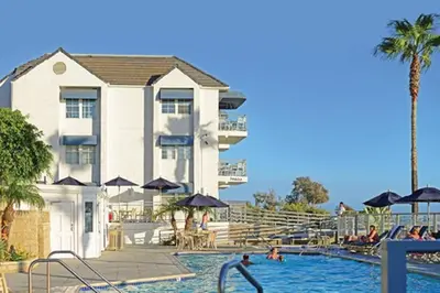 a resort with a swimming pool and a building at Diamond - Riviera Beach and Spa Resort 1bd in Dana Point