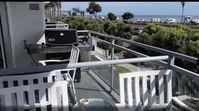 a balcony with a laptop computer sitting on a table at Diamond - Riviera Beach and Spa Resort 1bd in Dana Point