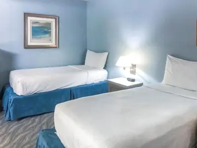 two beds in a hotel room with blue walls at Diamond - Riviera Beach and Spa Resort 2bd in Dana Point