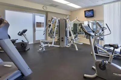 a gym with several treadmills and elliptical machines at WorldMark Oceanside 2BD in Oceanside