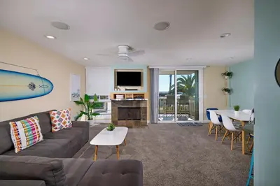 a living room with a couch and a table at Oceanside Beach Condos in Oceanside