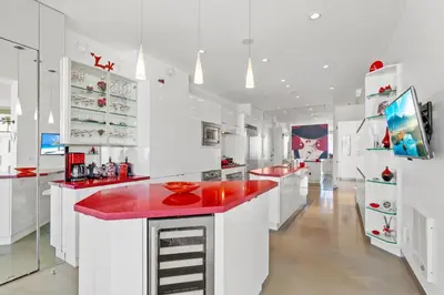 a large white kitchen with red counter tops at Jewel of La Jolla in San Diego