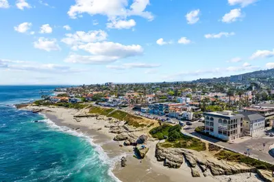 an aerial view of a beach with buildings and the ocean at Jewel of La Jolla in San Diego
