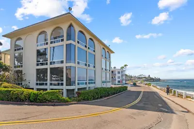 a building on the side of a road next to the ocean at Jewel of La Jolla in San Diego