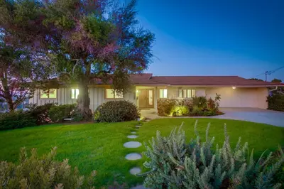 a house with a lawn in front of it at Red Hawk Coastal Estate in San Diego