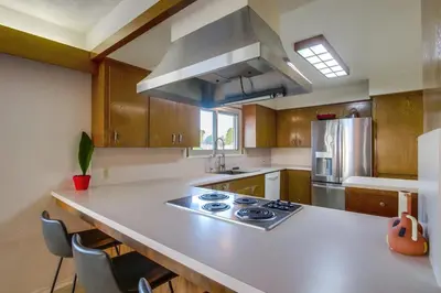 a kitchen with a counter with a stove top oven at Red Hawk Coastal Estate in San Diego
