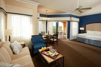 a hotel room with a king bed and a living room at Carter Estate Winery and Resort in Temecula