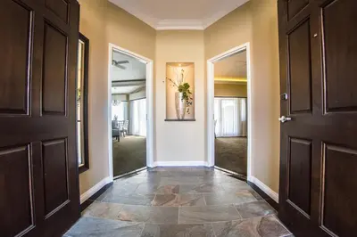 a hallway with two doors and a entry way at Carter Estate Winery and Resort in Temecula