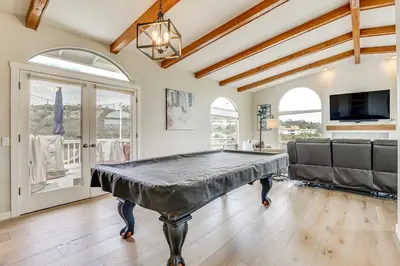 a ping pong table in a room with a couch at San Marcos Getaway with Deck and Lake Views! in San Marcos