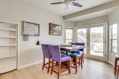 a dining room with a table and purple chairs at San Marcos Getaway with Deck and Lake Views! in San Marcos