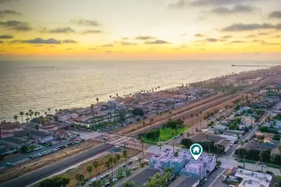 an aerial view of a city and the ocean at Blocks To Beach - Coastal Beach Decor - Garage Parking - Gated Community - 30 Day Fully Furnished in Oceanside