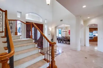 a staircase in a home with a dining room at Villa Andalusia 6BR 5BA Luxury Jacuzzi Views and Games in Escondido