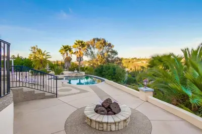 a patio with a fire pit and a swimming pool at Villa Andalusia 6BR 5BA Luxury Jacuzzi Views and Games in Escondido