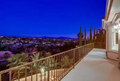 a balcony with a view of the city at night at Villa Andalusia 6BR 5BA Luxury Jacuzzi Views and Games in Escondido