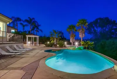 a swimming pool in a backyard at night at Villa Andalusia 6BR 5BA Luxury Jacuzzi Views and Games in Escondido