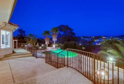 a balcony of a home at night with a pool at Villa Andalusia 6BR 5BA Luxury Jacuzzi Views and Games in Escondido