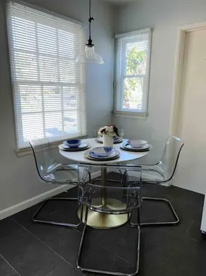 a dining room table and chairs in a room with a table and chairsktop at The Downtown Blue Bungalow Escape in San Diego