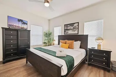 a bedroom with a large bed and two dressers at Catch n' Relax on Nimitz- Minutes from the Harbor in San Diego
