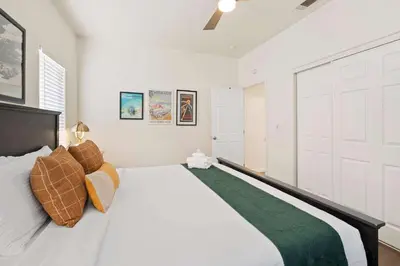 a bedroom with a large bed with white walls at Catch n' Relax on Nimitz- Minutes from the Harbor in San Diego