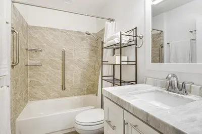 a bathroom with a sink and a toilet and a tub at Oceanside Condo with Pool and Hot Tub Access! in Oceanside