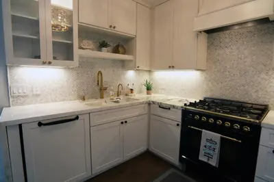 a kitchen with white cabinets and a stove and sink at La Jolla Beach Villa Gem in San Diego