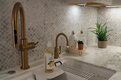 a kitchen sink with two faucets and two bottles of soap at La Jolla Beach Villa Gem in San Diego