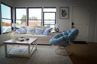 a living room with a couch and a table at La Jolla Beach Villa Gem in San Diego