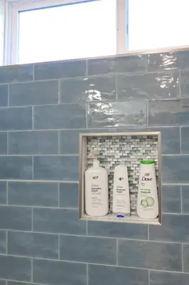 a shelf with three bottles of soap in a bathroom at Pristine Poway Retreat in Poway