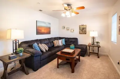 a living room with a couch and a ceiling fan at Stylish Country Home with Hot Tub and Amazing Views on 40 Acres in Ranchita