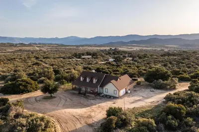 an aerial view of a house in the middle of a field at Stylish Country Home with Hot Tub and Amazing Views on 40 Acres in Ranchita