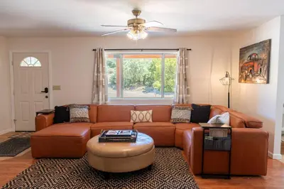a living room with a couch and a table at Stylish Country Cowboy Home with Hot Tub on 20 Acres in Borrego Springs
