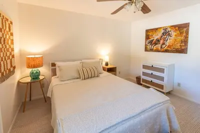 a bedroom with a bed and a ceiling fan at Stylish Country Cowboy Home with Hot Tub on 20 Acres in Borrego Springs