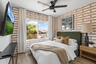 a bedroom with a bed and a window at Spacious Mission Hills Home With City Views in San Diego
