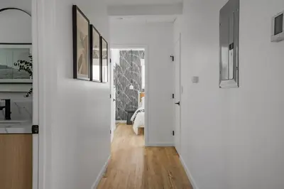 a hallway of a home with white walls and wood floors at Spacious Mission Hills Home With City Views in San Diego