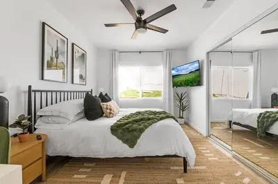 a bedroom with a bed and a ceiling fan at Spacious Mission Hills Home With City Views in San Diego