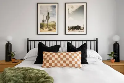 a bedroom with a bed with four pictures on the wall at Spacious Mission Hills Home With City Views in San Diego