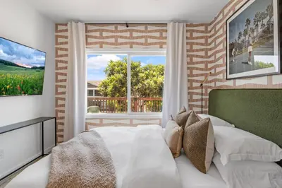 a bedroom with a white bed and a large window at Spacious Mission Hills Home With City Views in San Diego