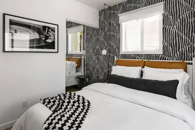 a bedroom with a bed with a black and white patterned wall at Spacious Mission Hills Home With City Views in San Diego