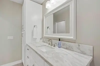 a white bathroom with a sink and a mirror at Endless Summer Beach Studio - Beach - AC - Shops in San Diego
