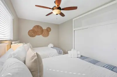 a bedroom with two beds and a ceiling fan at Endless Summer Retreat - Beach - AC - Shops in San Diego