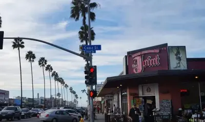 a traffic light and a street sign on a city street at Endless Summer Retreat - Beach - AC - Shops in San Diego