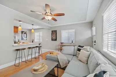 a living room with a couch and a ceiling fan at Endless Summer Retreat - Beach - AC - Shops in San Diego