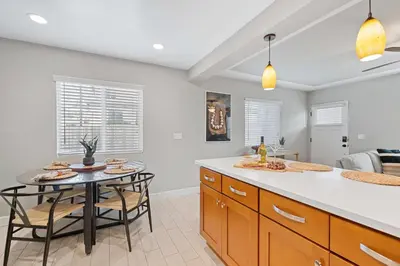 a kitchen with a table and chairs and a dining room at Endless Summer Retreat - Beach - AC - Shops in San Diego