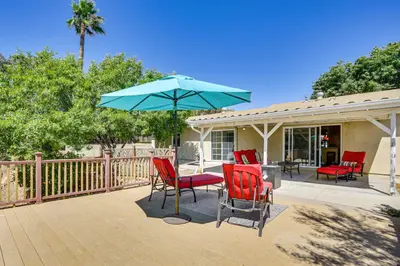 a patio with chairs and a table with an umbrella at Poway Retreat with Stunning Sunset and Mountain Views! in Poway