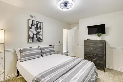 a bedroom with a bed and a flat screen tv at Poway Retreat with Stunning Sunset and Mountain Views! in Poway