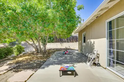 a backyard with a table and a chair and a tree at Poway Retreat with Stunning Sunset and Mountain Views! in Poway