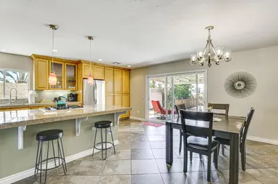 a kitchen and dining room with a table and chairs at Poway Retreat with Stunning Sunset and Mountain Views! in Poway