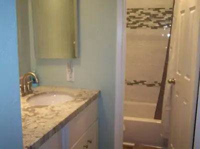 a bathroom with a sink and a bath tub at Ocean Breeze 2 bedroom in San Diego