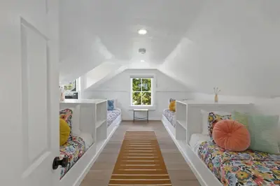 a room with white walls and a hallway with couches at 5BD Home with outdoor space in Little Italy in San Diego